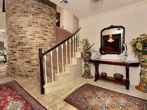 Stair case with bricked decorator wall.