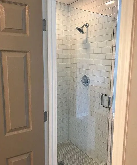 master shower with frameless glass door