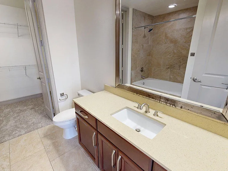 Apartment Bathroom with large soaking tub and Tile Flooring.