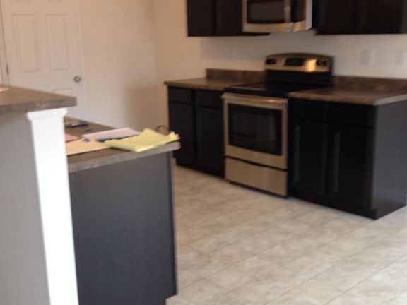 Open Kitchen With Upgraded Cabinets And Breakfast Bar