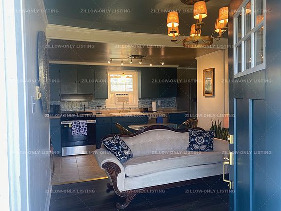 Cozy cottage has laminate wood floors throughout and tile in the kitchen area.