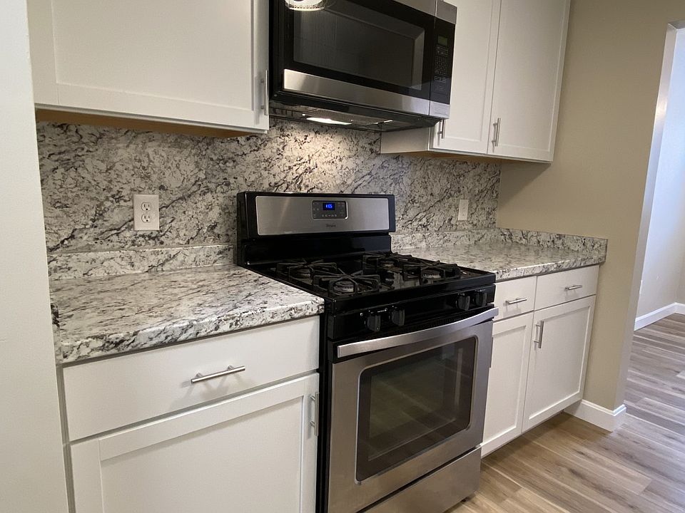 New kitchen with ceiling height cabinets and stainless steel appliances.