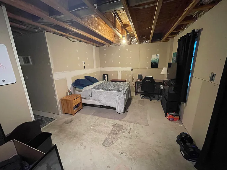 Un finished room in back of first floor. Sometimes used at a 4th bedroom since this floor has a half bath.