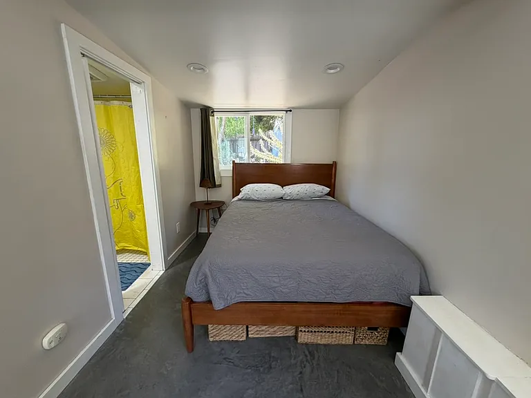 Queen bed with new mattress.
Storage baskets below bed for your knick knacks.