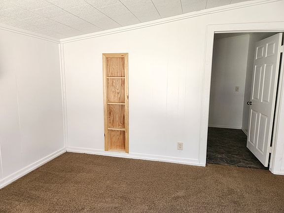 Shelves on southside of large livingroom & door to laundryroom