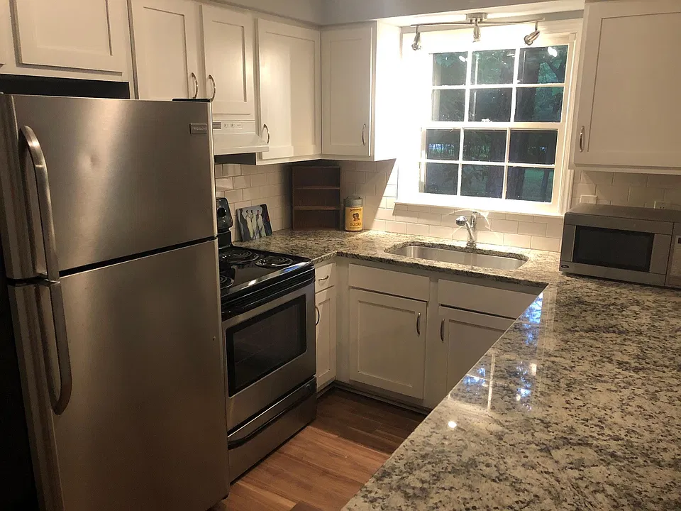 Kitchen includes granite counter tops, stainless steel refrigerator, stove and dishwasher.
