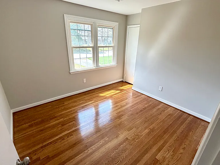 4th bedroom with hardwood floors.