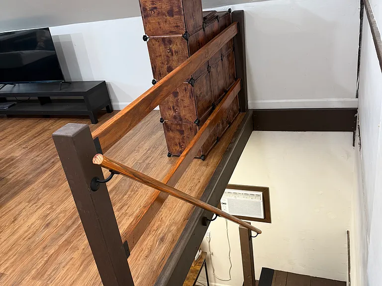 Stairwell leading to the loft space with custom, stained railings - they are removable if needed to get furniture in.