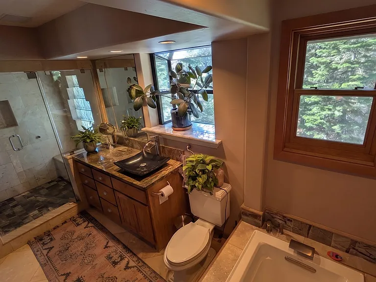 Primary ensuite bathroom includes tub, steam sauna, and shower