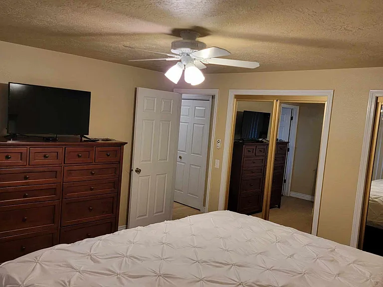 Master bedroom with mirrored closet doors