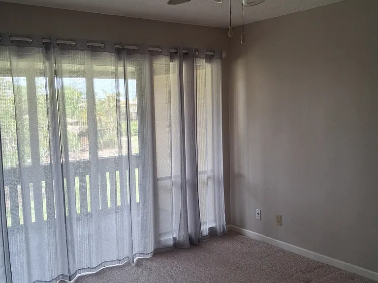 Master Bedroom view with sliders to the screened patio.