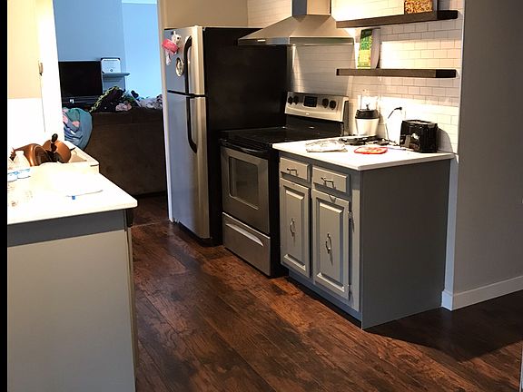 Updated kitchen includes- quartz countertops, floating shelves, farmhouse sink & subway tile