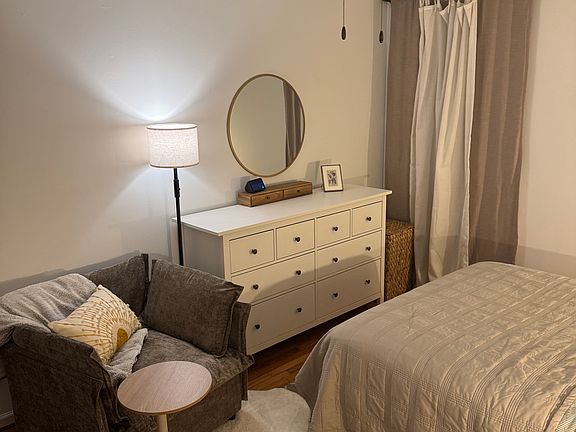 Master bedroom - room darkening curtains, dresser, cozy chair with small moveable work top.