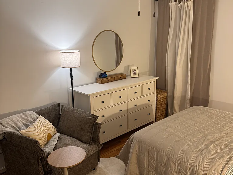Master bedroom - room darkening curtains, dresser, cozy chair with small moveable work top.