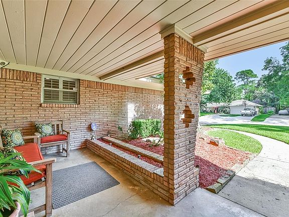 The inviting front porch features a planked ceiling, landscaping bed and walkway to the driveway.  The home is equipped with a sprinkler system.