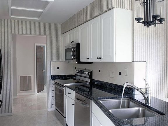 Upgraded kitchen with stainless steel appliances.