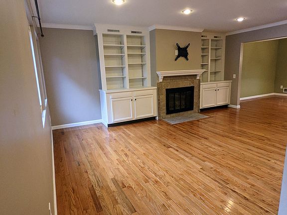 Living room with built in bookcases and fireplace.