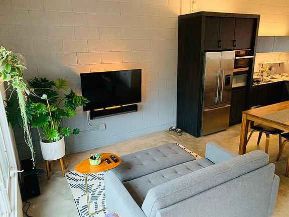 Living area with TV/Sonos stereo mounted on an adjustable arm so you can watch from couch or dining area. Supplemental Phillips Hue lighting adjustable from your smartphone.