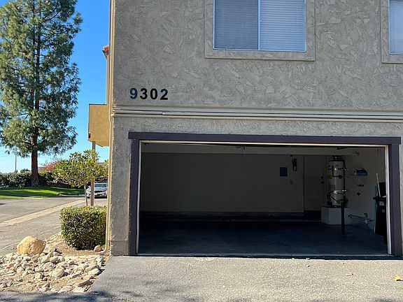 East side of building -Unit G garage door open