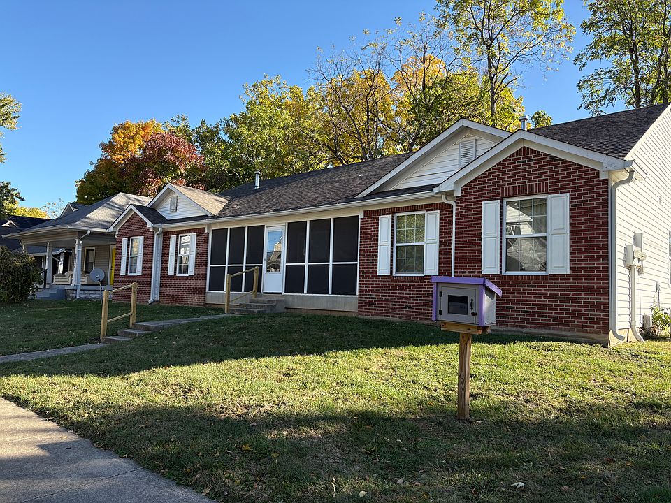 Street view of the Double with screened porch and red brick veneer