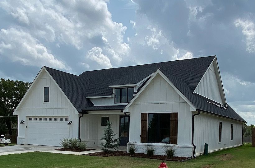 Front with inviting porch and beautiful landscaping
