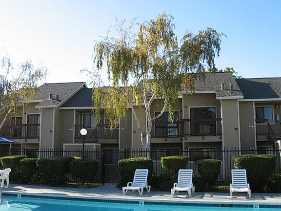 The pool area also includes a barbecue grill
