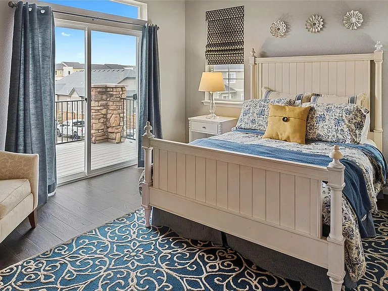 Spacious primary bedroom with balcony access