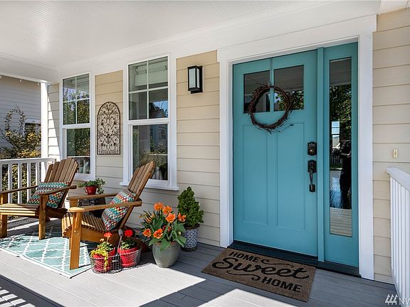 Welcoming covered front porch catches the morning sun. A wonderful place to enjoy morning coffee!