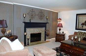 Large living room with beautiful mantle above the gas fireplace.