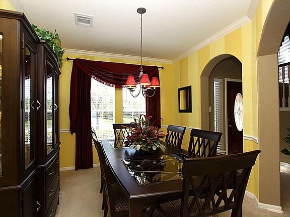 The foyer opens to the classic formal dining room with arched openings. The room is ready to enterta