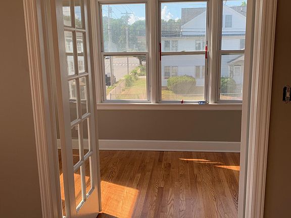 Light filled Sunroom surrounded by newer windows that pull out for easy cleaning!