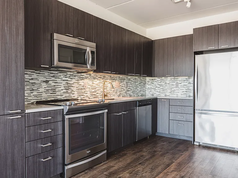 Designer glass tile backsplash with upscale kitchen finishes