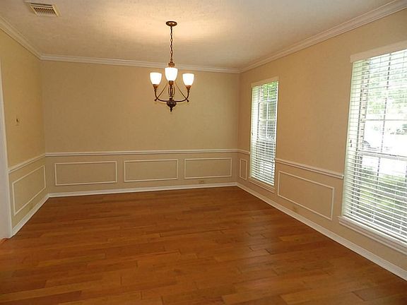 Formal Dining with recent Hardwood flooring, fresh paint, crown and accent molding, chair rails, updated Chandelier and new (5/13) 2" blinds.  Great for romantic dinners or holiday festivities!