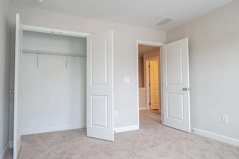 View of the closet in one of 2 secondary bedrooms