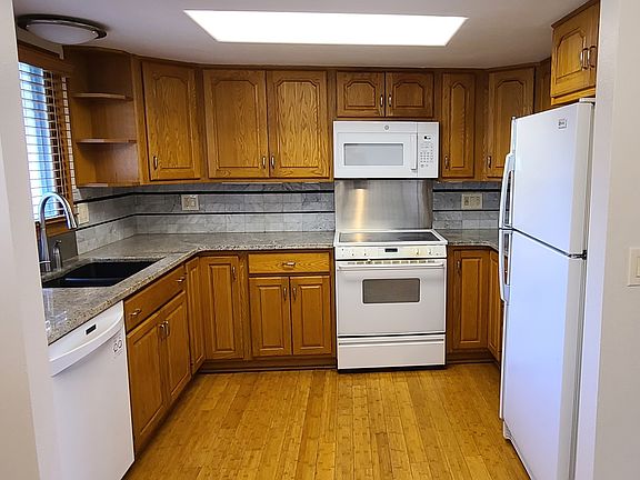 Main floor kitchen: granite countertops, glass-top stove, bamboo flooring