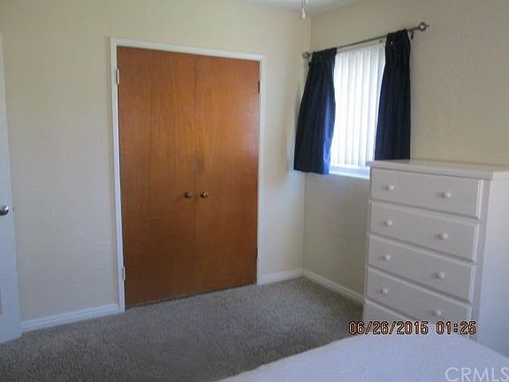 Master bedroom with carpet and closet space.