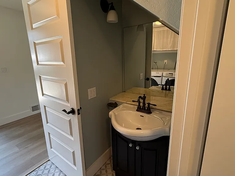 Downstairs half bathroom that also includes the washer/dryer