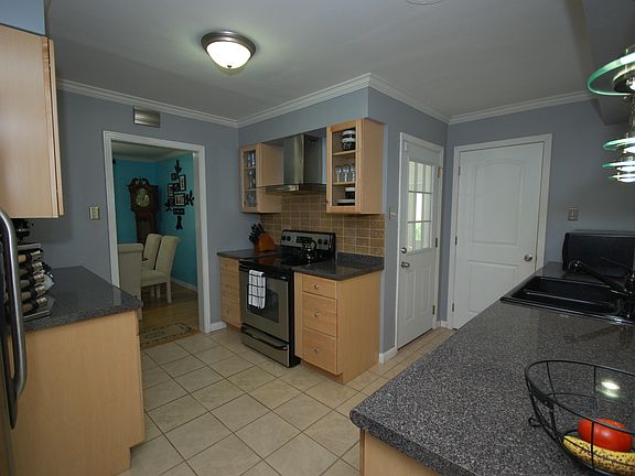 Updated kitchen with tile flooring, beautiful wooden cabinets, and much more.