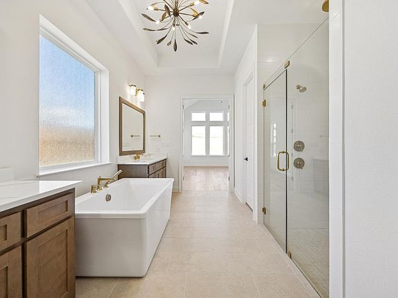 Luxurious primary bathroom with oversized shower and soaking tub