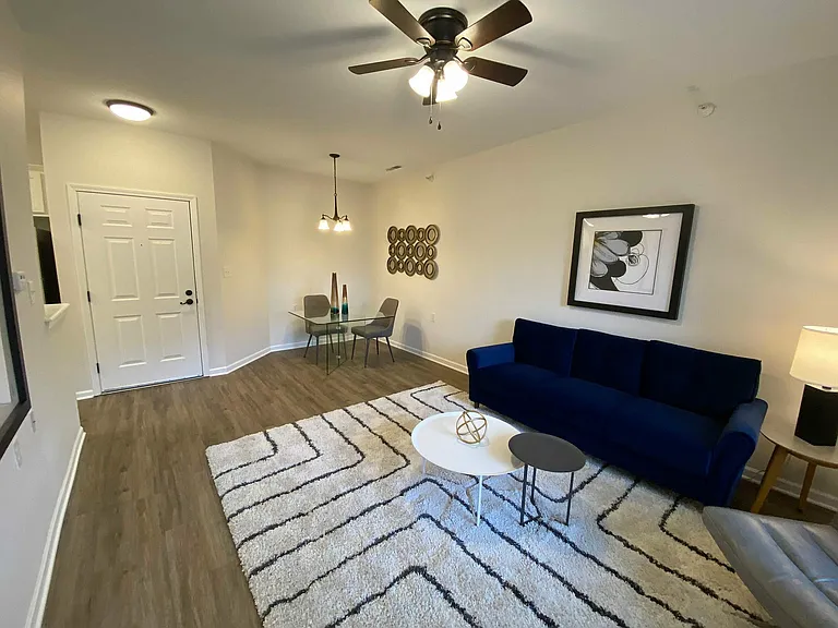 Bright, open, and ready to make your own, this spacious living room features a cozy nook that's perfect for dinners, work sessions, or a brunch spot.
