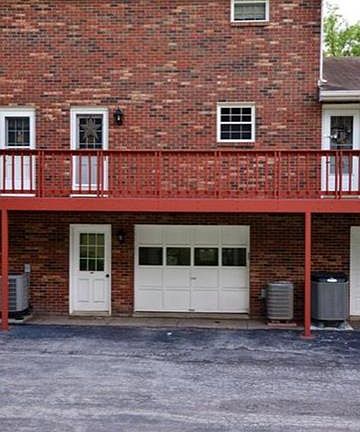 Garage in rear of building with a door opener