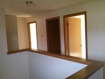 Upstairs hallway showing 2 bedrooms and middle bathroom