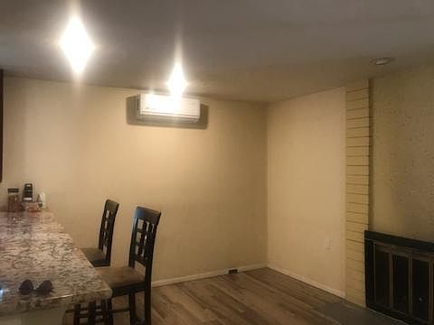 Family room with granite counter top. Room has ductless AC and heat unit, and the fireplace.