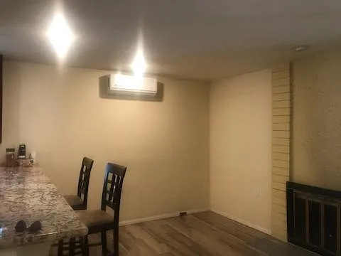 Family room with granite counter top. Room has ductless AC and heat unit, and the fireplace.