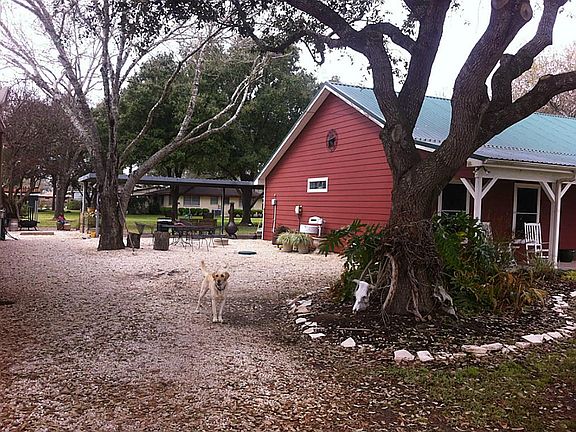 Limestone covered area connecting home to barn and game room affords easy maintenance and a clean lo