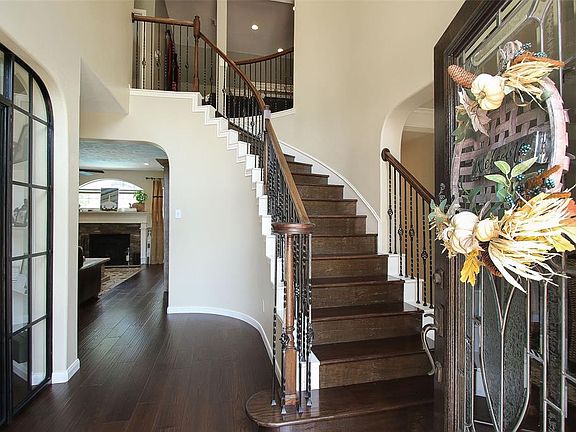 A true wow upon entering the foyer with hand scraped flooring and stairway with iron spindles.