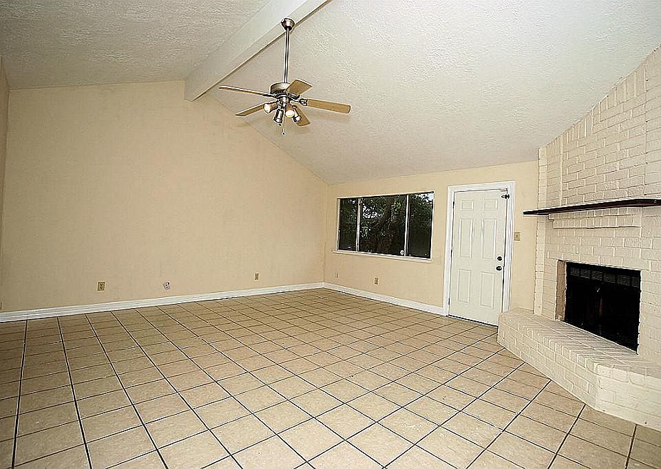 Family room features fresh paint, gorgeous tile floors, vaulted ceiling, brick fireplace!