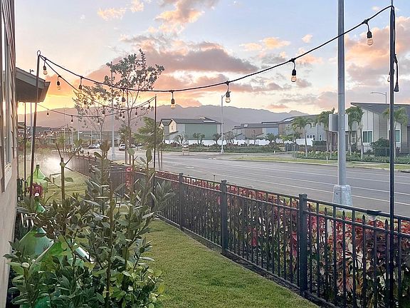 Backyard with small lanai during evening sunset.