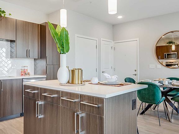 Apartment homes at The Wright feature modern kitchens with quartz-style countertops, sleek cabinetry, stainless steel appliances, and spacious islands designed for cooking, dining, and entertaining.