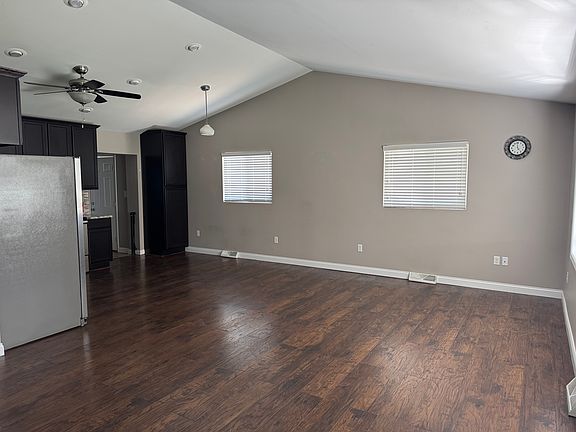Open Kitchen, Dining Area, and Living Room with vaulted ceilings and modern kitchen.